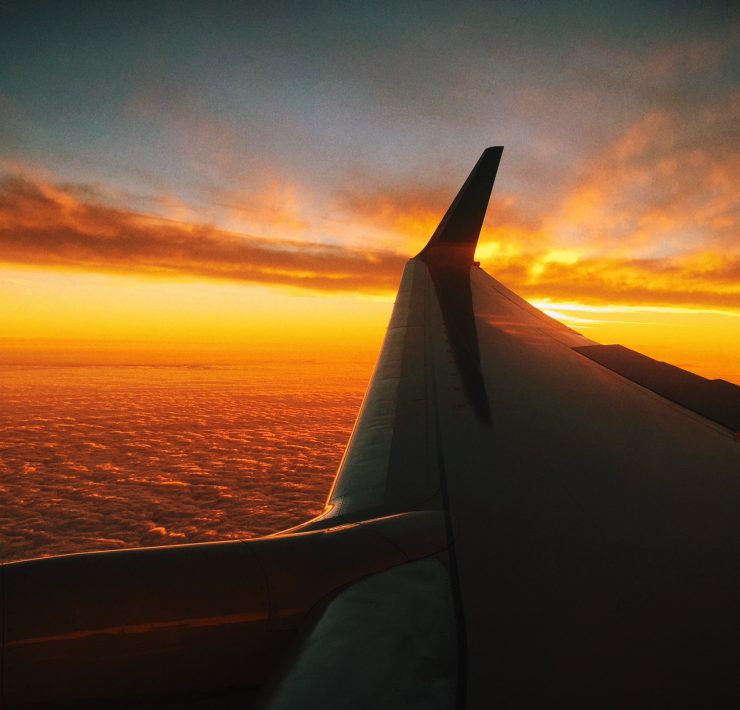 an airplane wing above the clouds