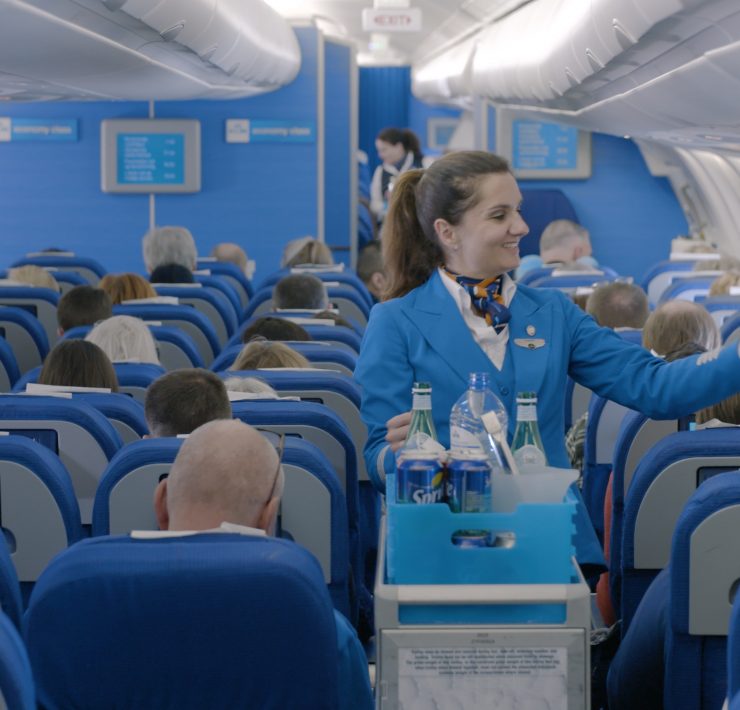 a woman in blue uniform in an airplane