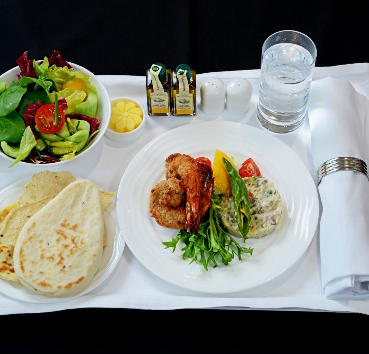 a plate of food and a salad on a tray
