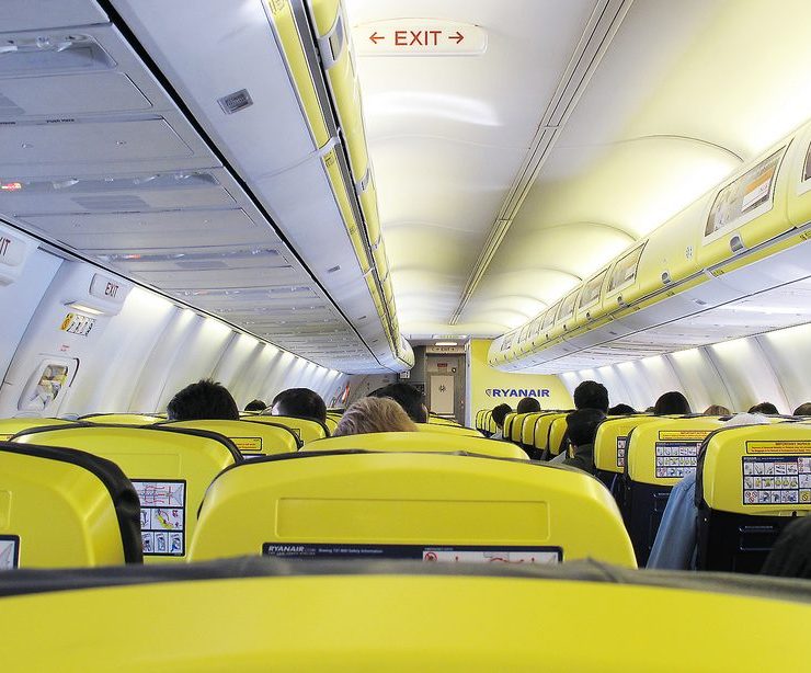a group of people sitting in an airplane