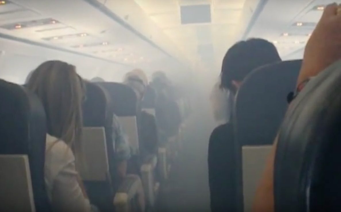 a group of people sitting in chairs in a plane