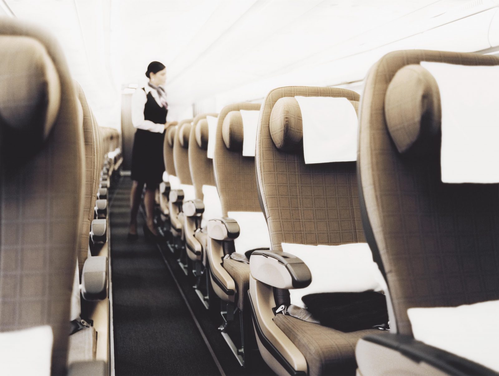 a woman standing in a row of seats