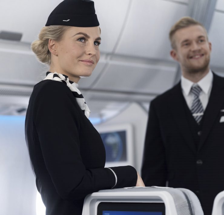 a woman in a black hat and black hat standing next to a man in a black hat