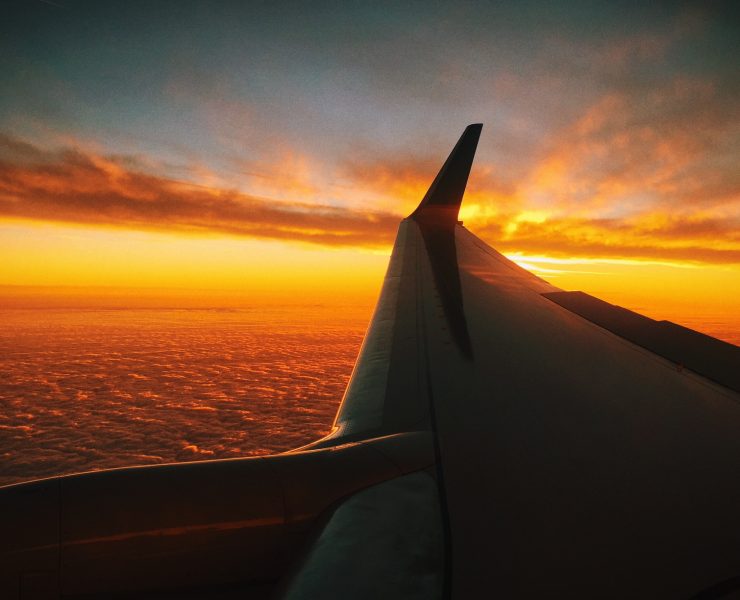 an airplane wing above the clouds
