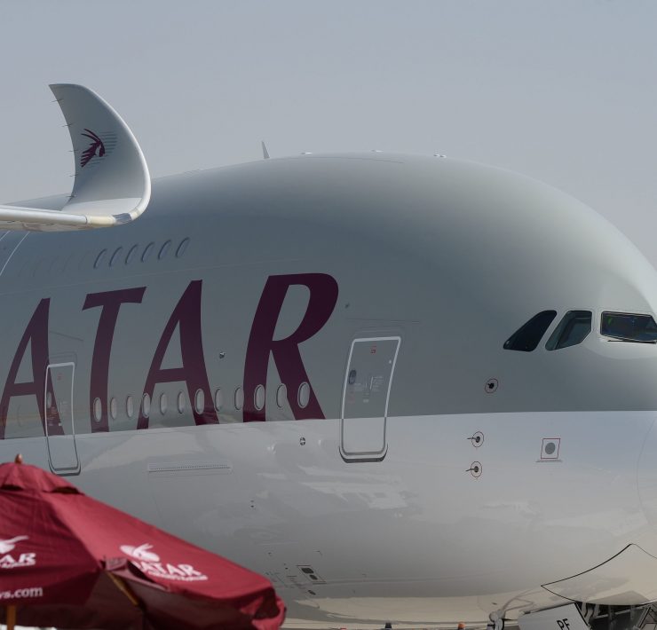 a large white airplane with red writing on it