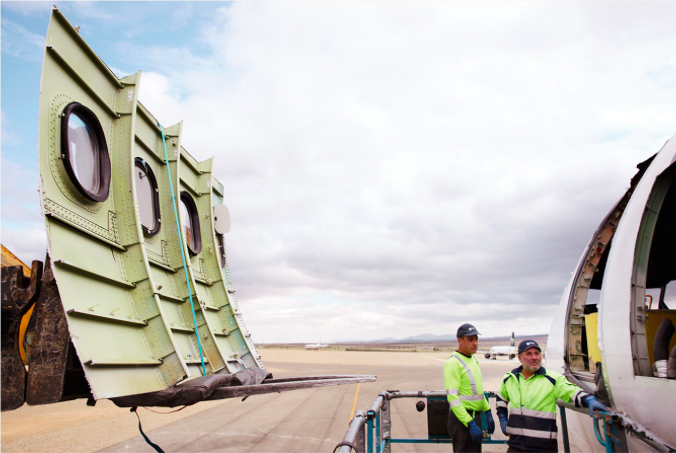 men standing next to a plane