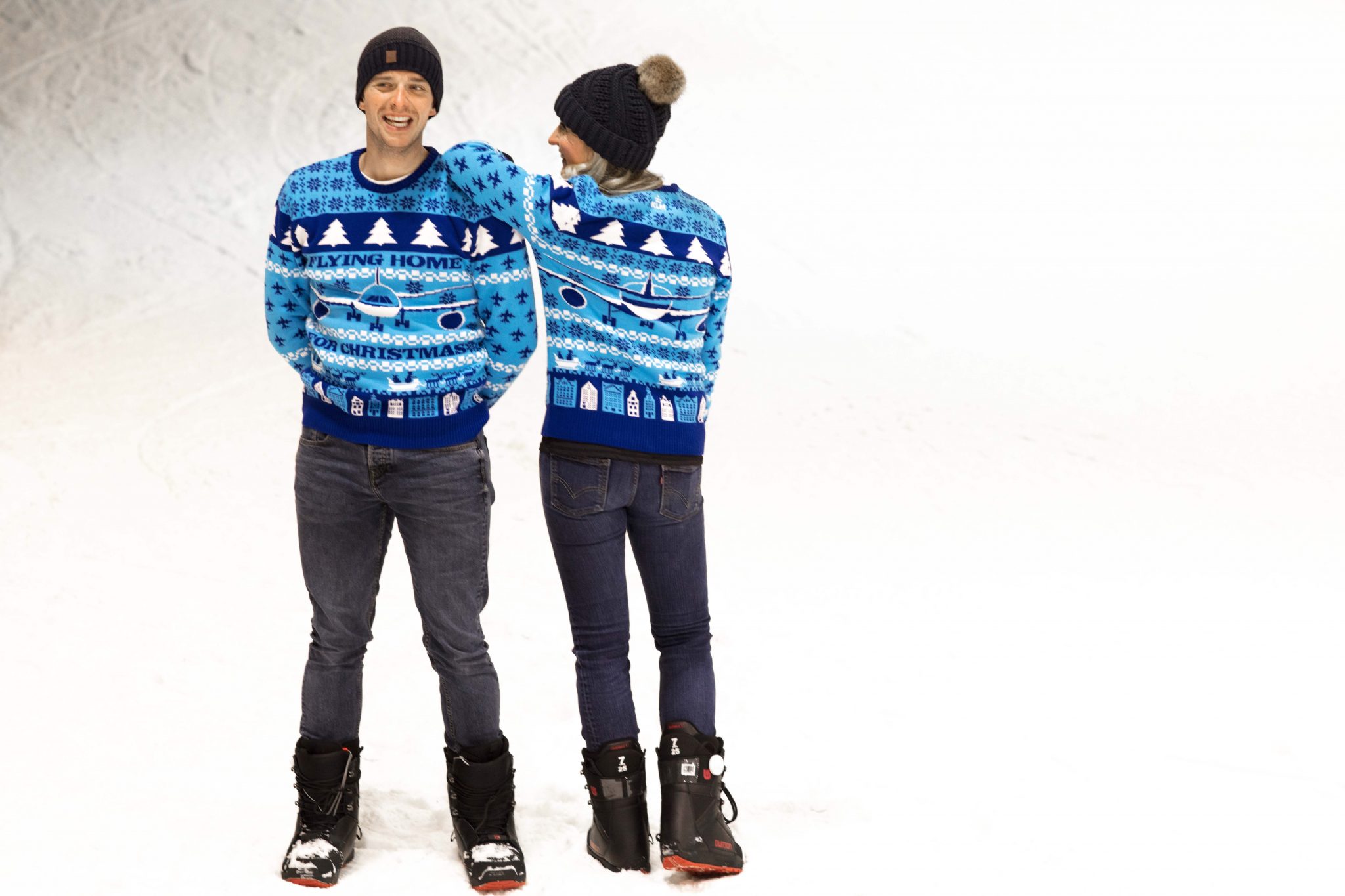 a man and woman in blue sweaters and hats