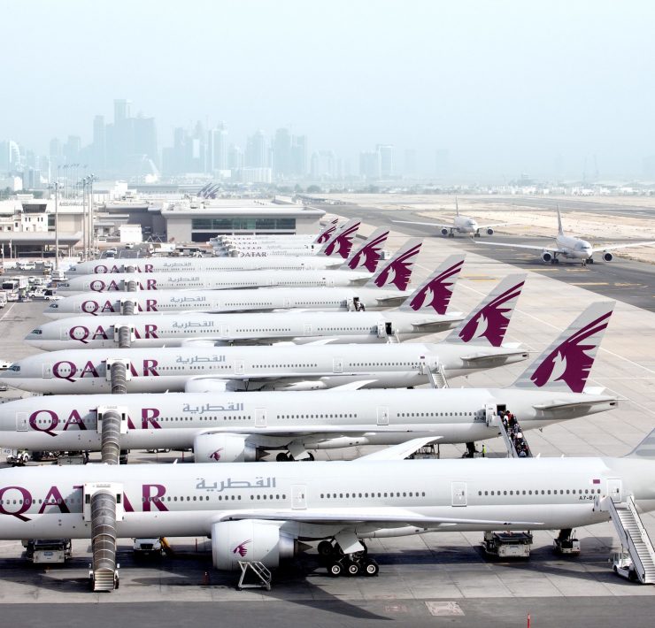 a group of airplanes parked on a runway