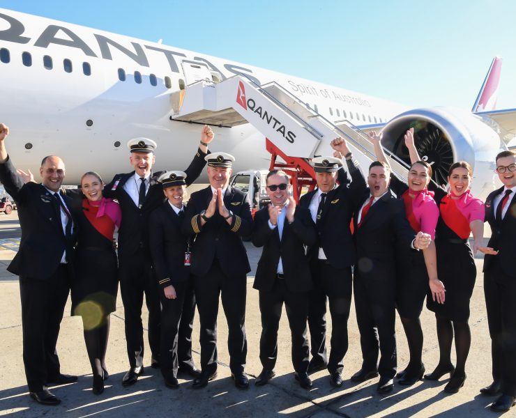 a group of people in uniform standing in front of an airplane