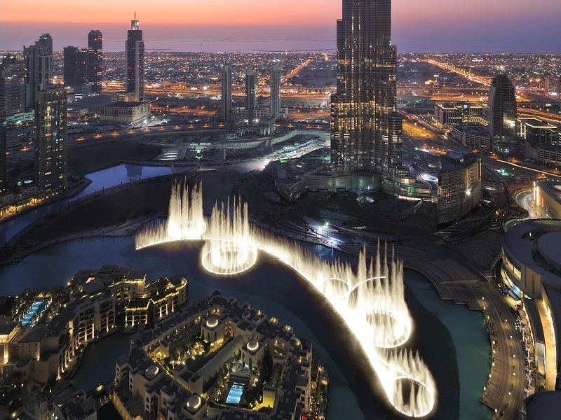 a city with water fountains and buildings