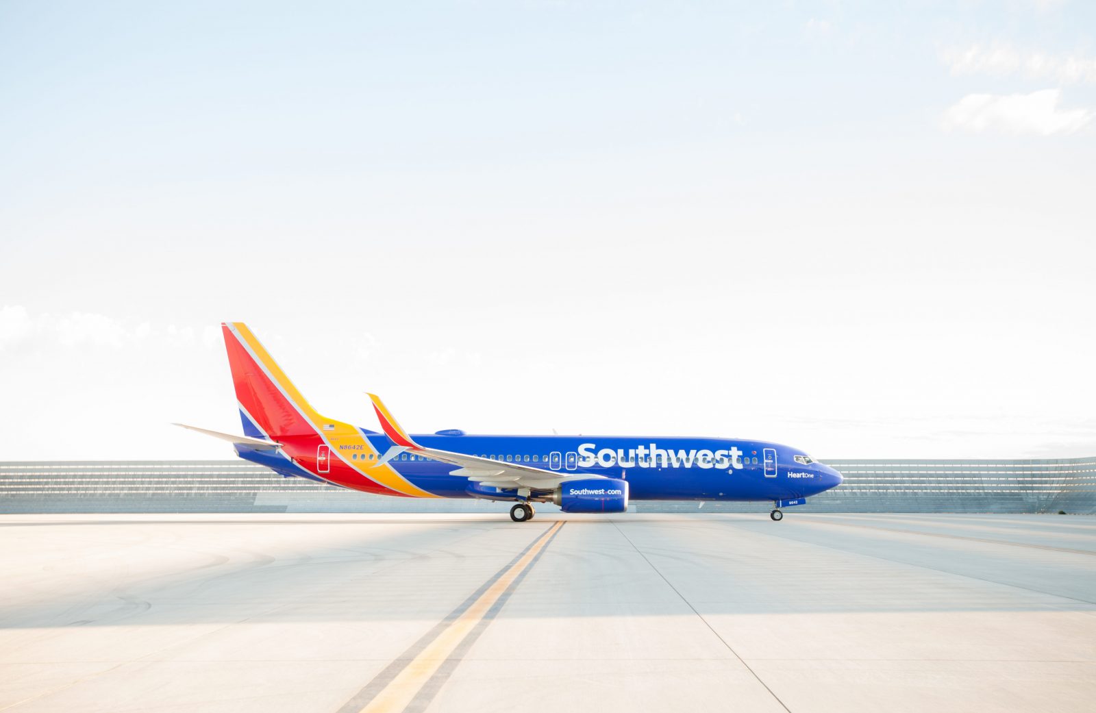 a blue airplane on a runway