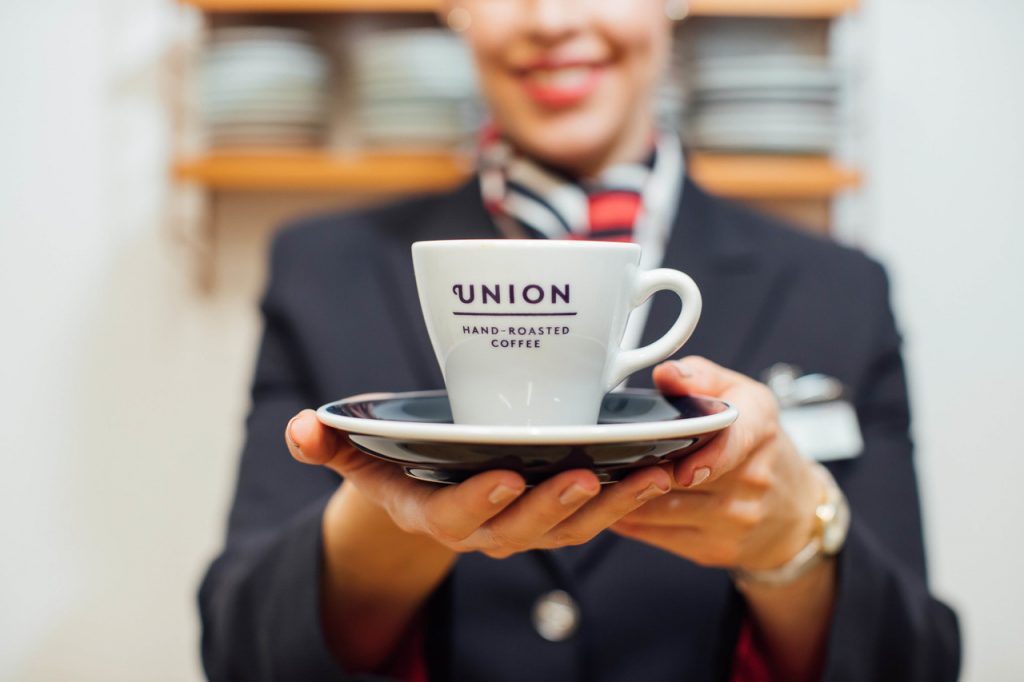 a woman holding a cup and saucer