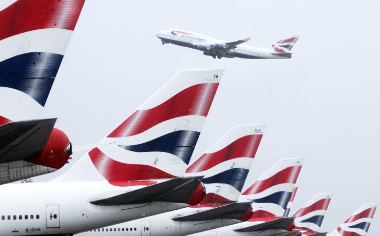 a group of airplanes with red white and blue tail fin
