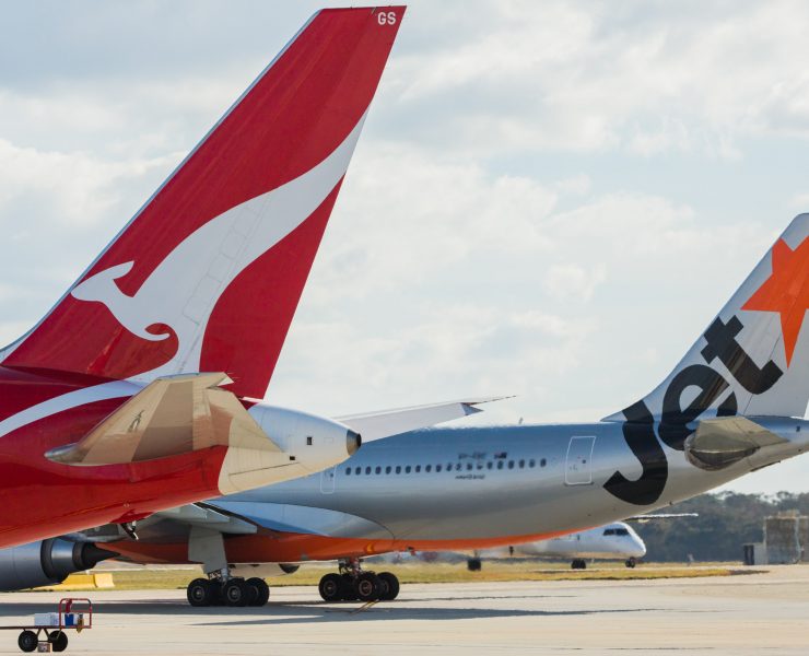 a group of airplanes on a runway