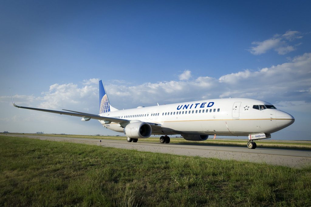 a white airplane on a runway