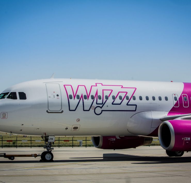 a white and pink airplane on a runway