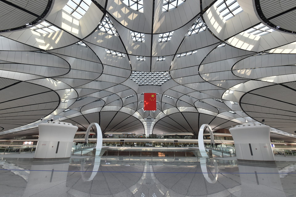 a large white and black ceiling with a red flag from the ceiling