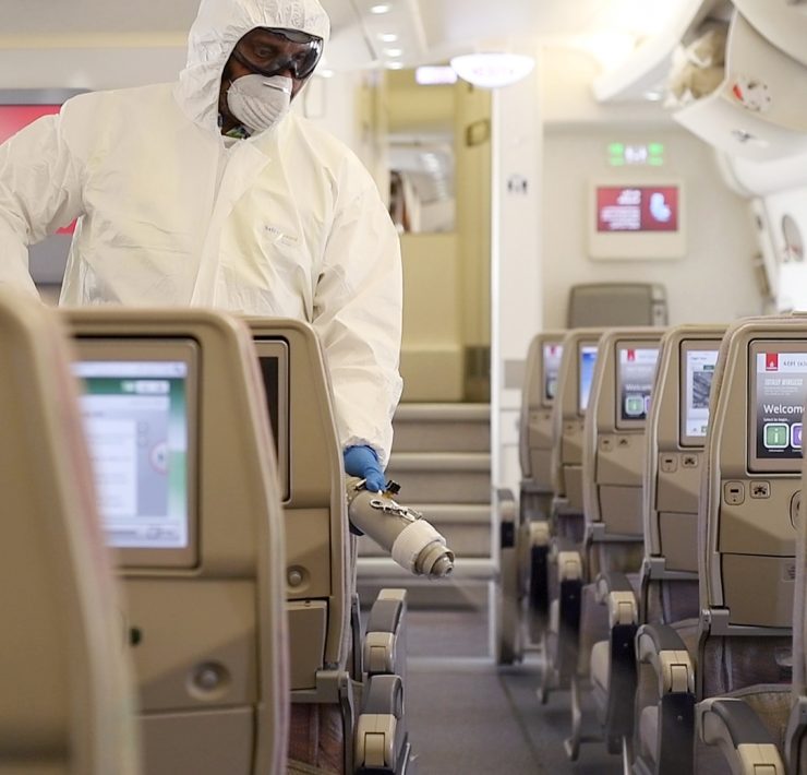 a person in a white suit and goggles in an airplane