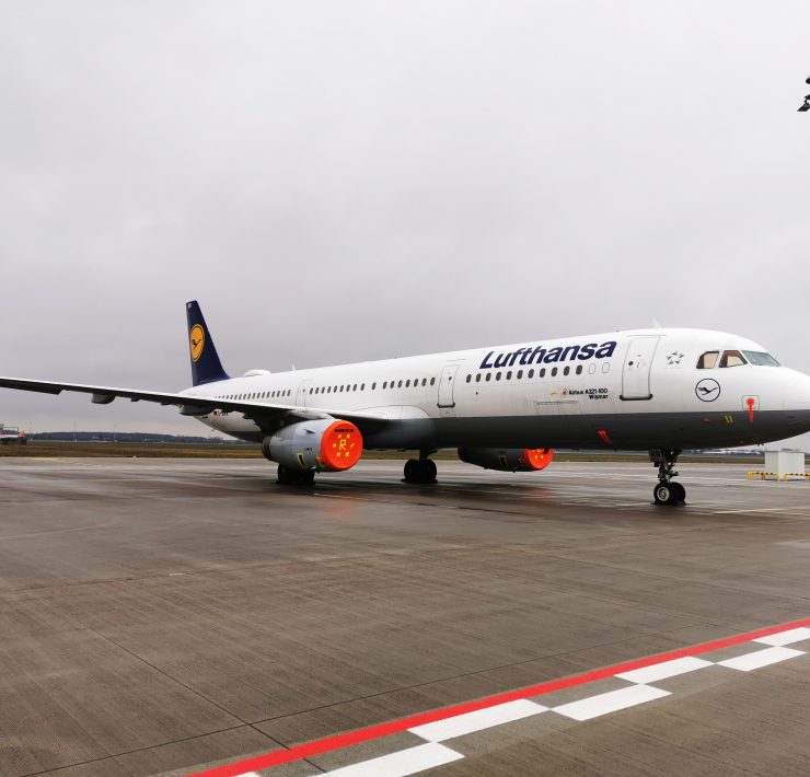 a white airplane on a runway