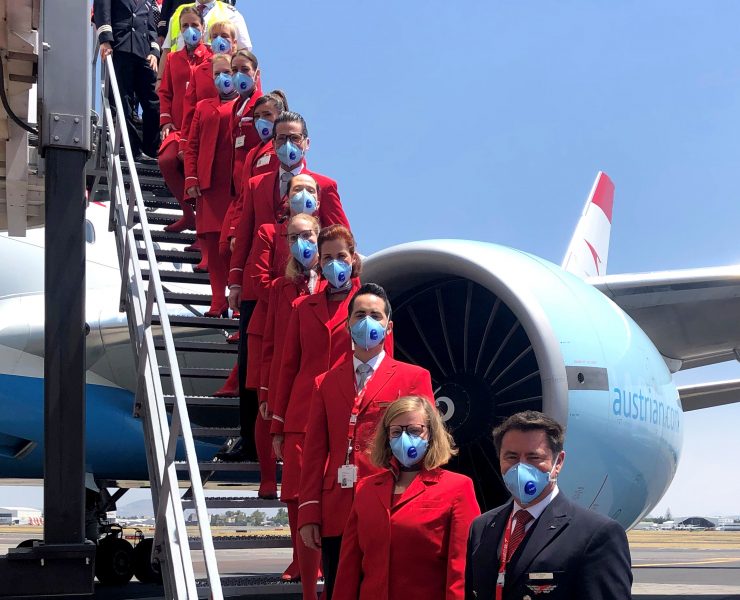 a group of people wearing face masks standing on stairs