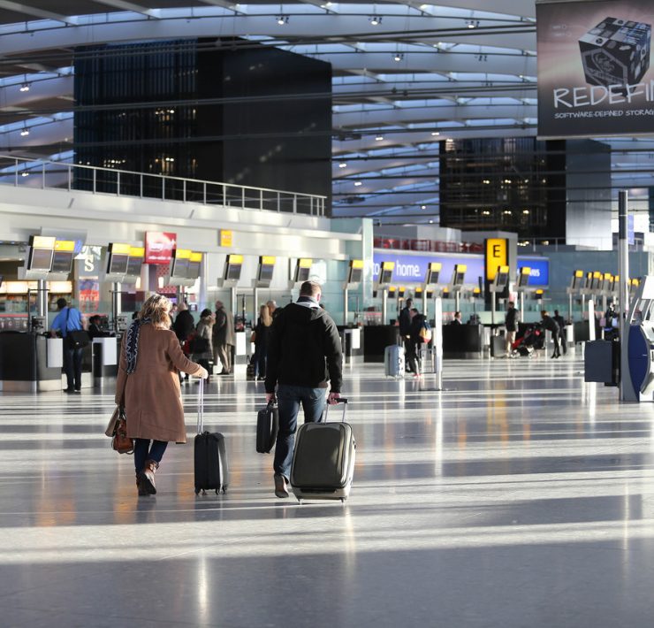 a man and woman with luggage in an airport