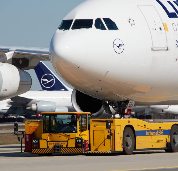 a large airplane with a yellow vehicle on the ground