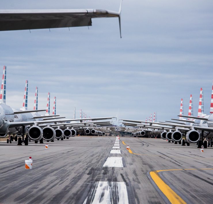 a row of airplanes on a runway
