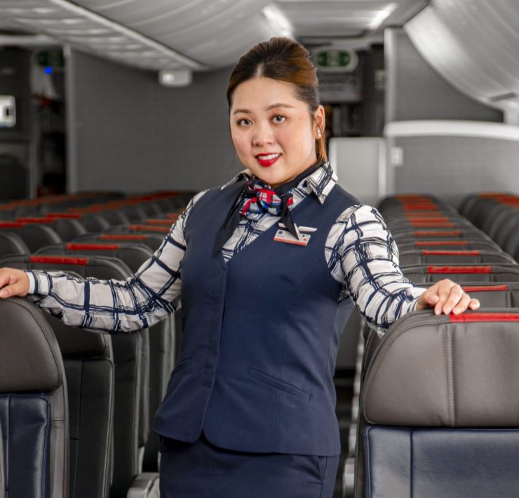 a woman standing in a row of seats