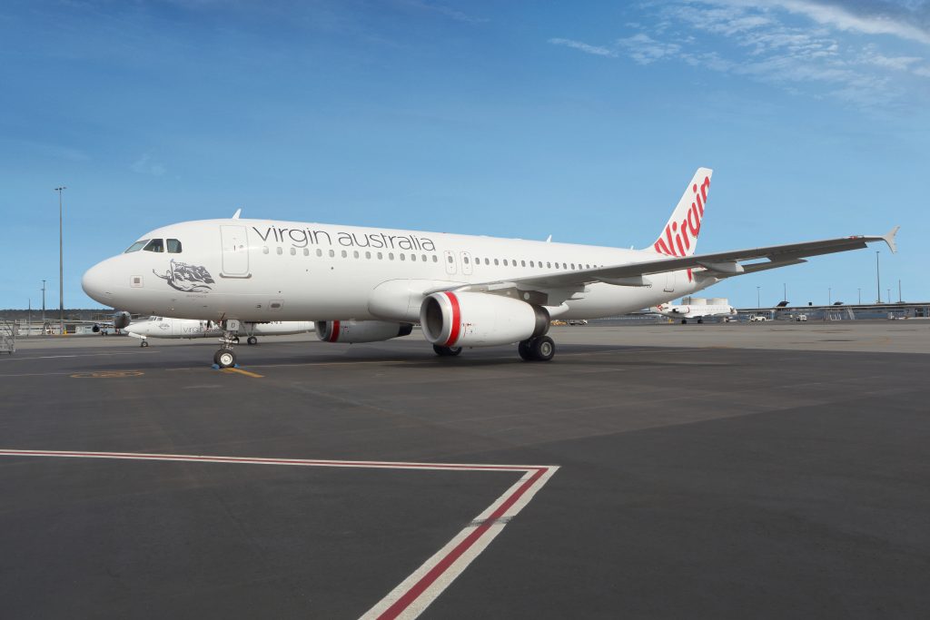 a white airplane on a runway
