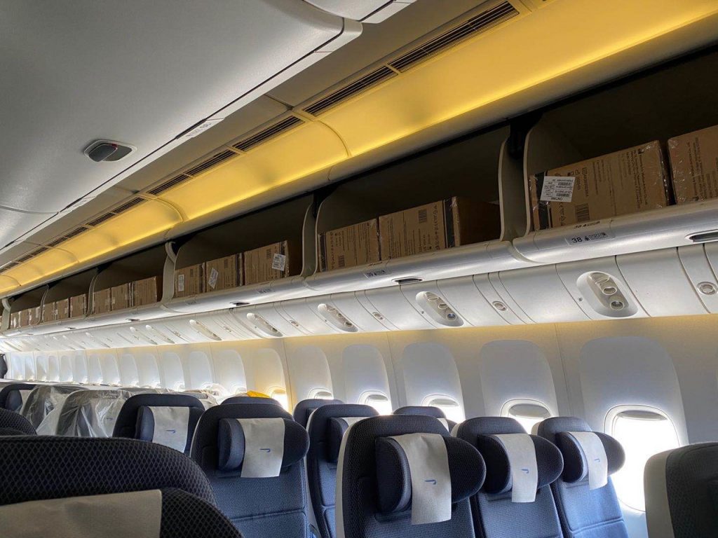 a row of boxes on the ceiling of an airplane