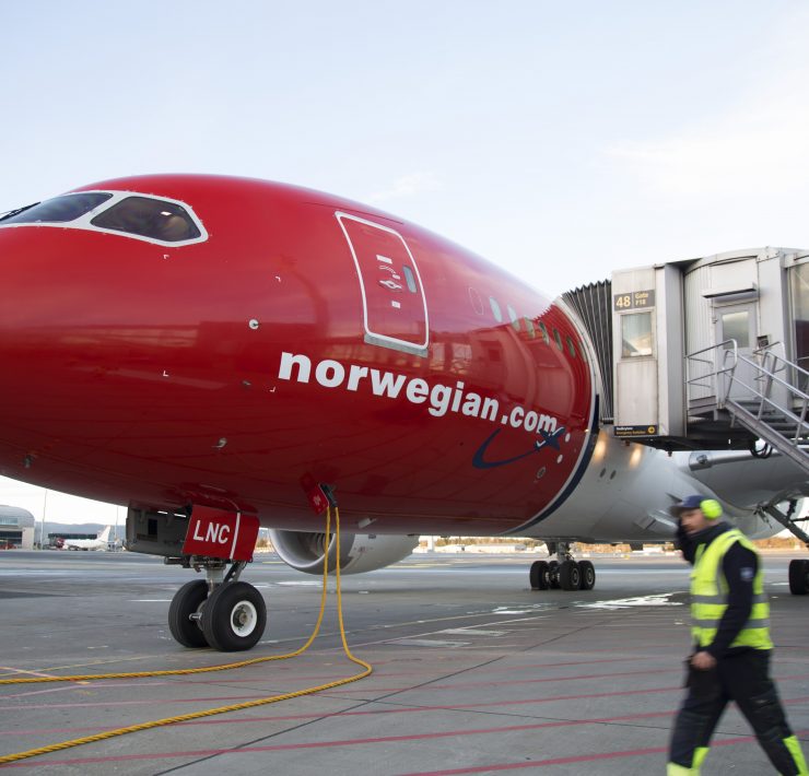 a red airplane with a white stripe on the front