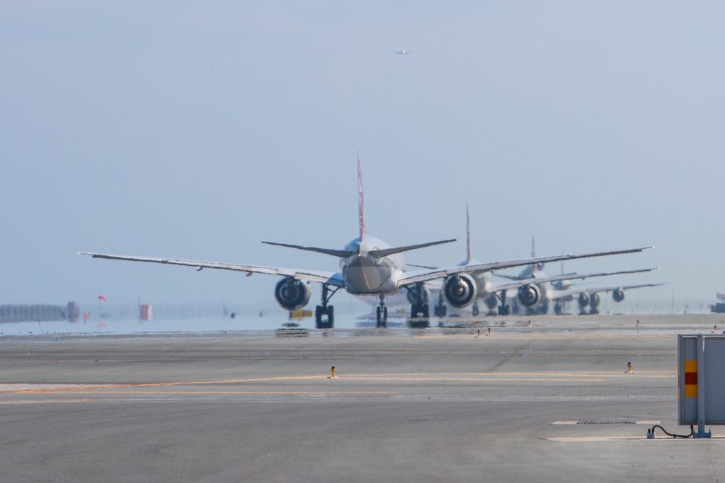 a group of airplanes on a runway