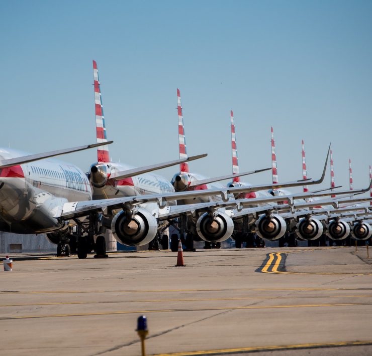 a row of airplanes on a runway