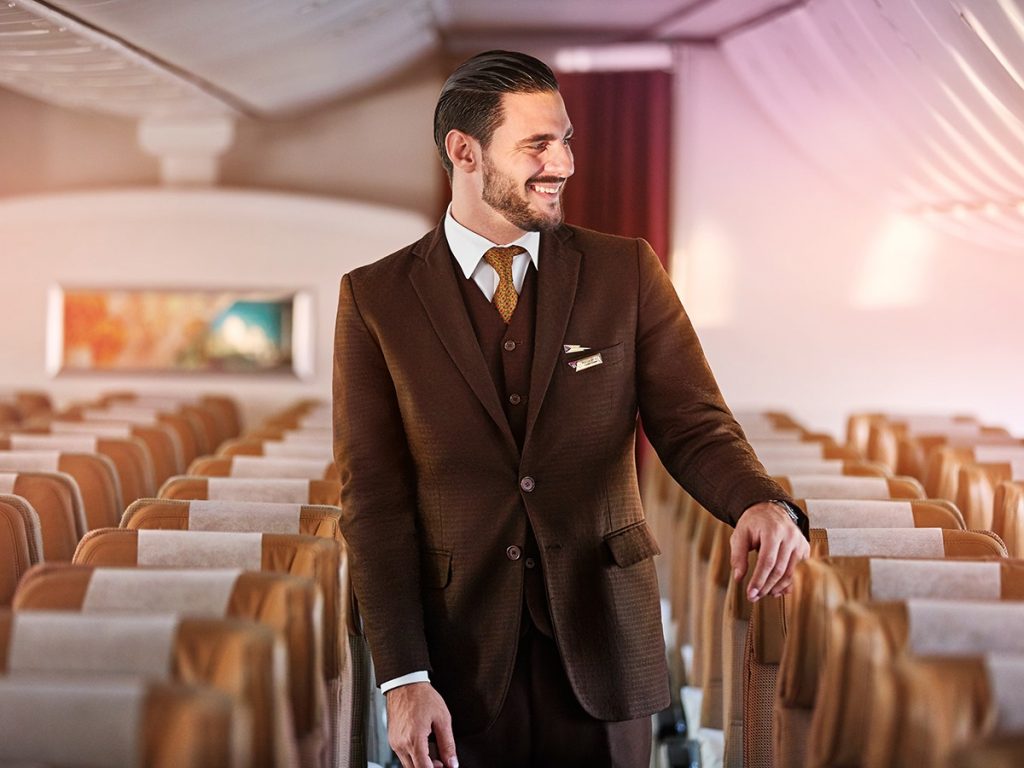 a man in a suit standing in a row of chairs