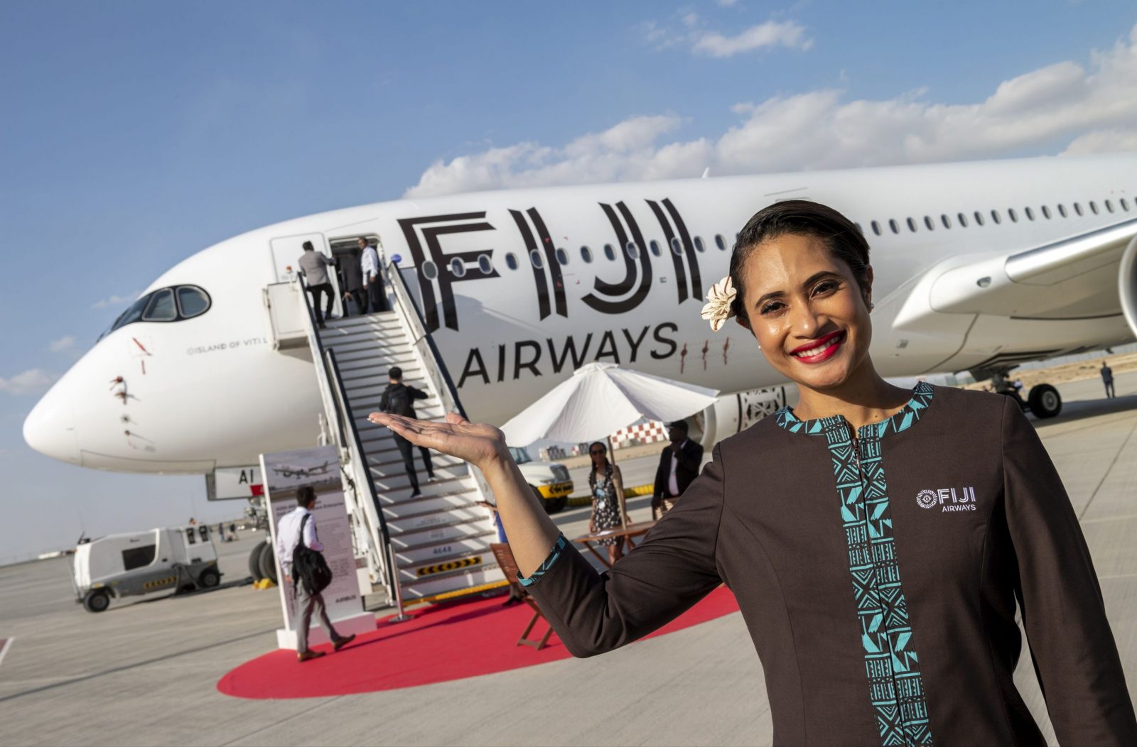a woman standing in front of an airplane