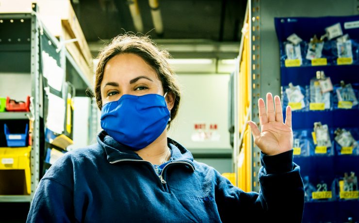 a woman wearing a blue face mask