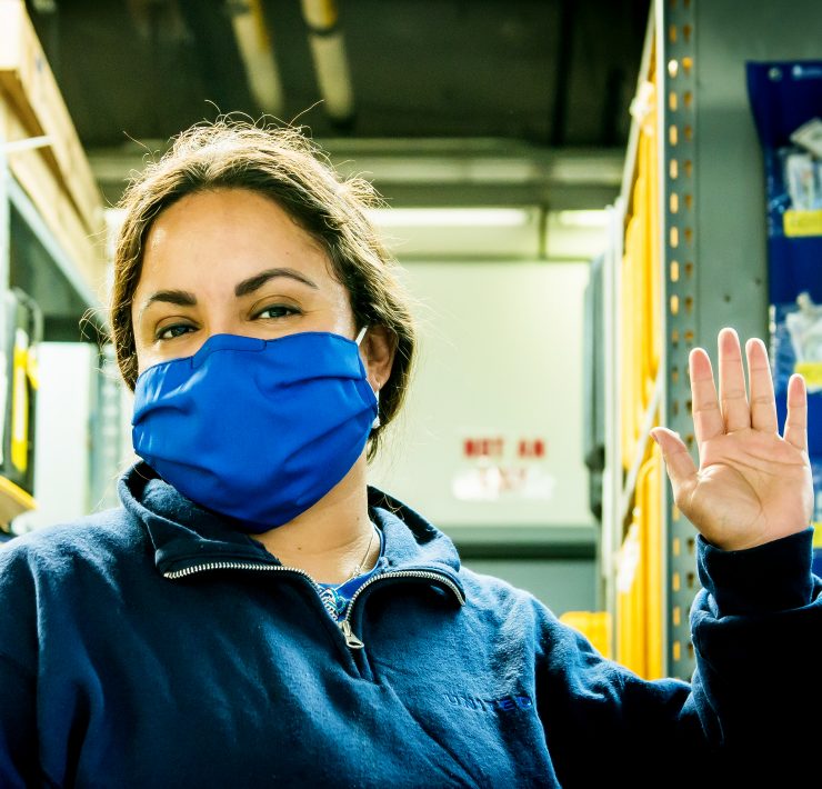 a woman wearing a blue face mask