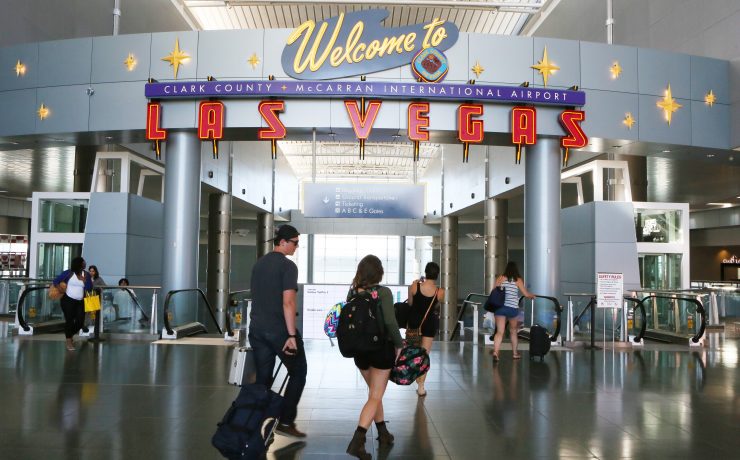 people walking in a building with luggage