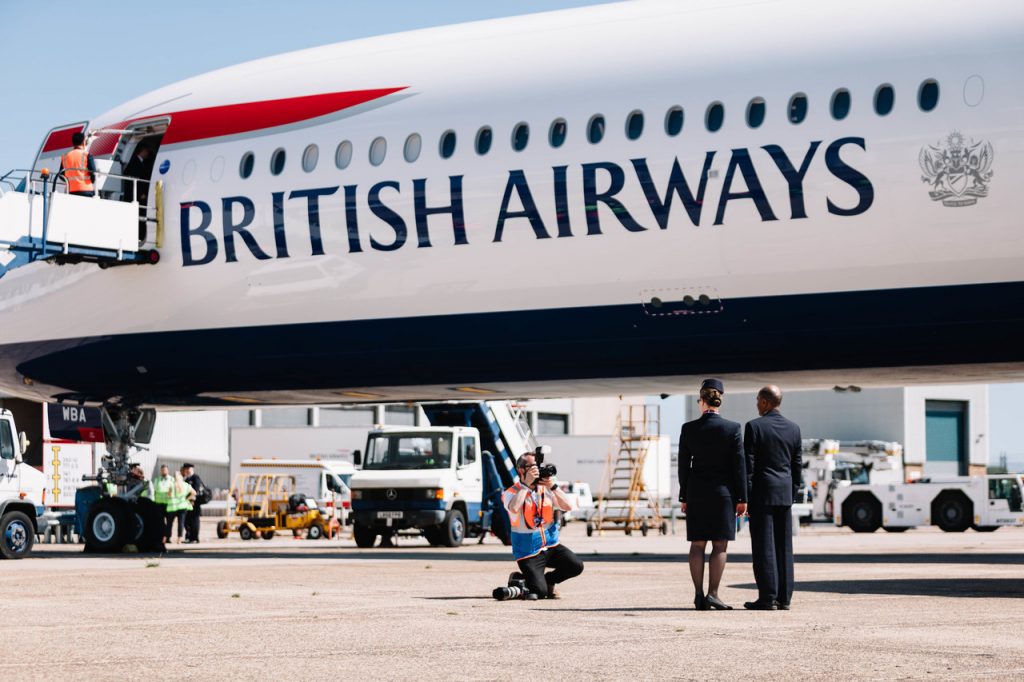 a group of people standing next to a large airplane