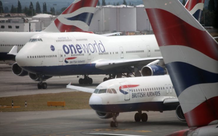 a group of airplanes on a runway
