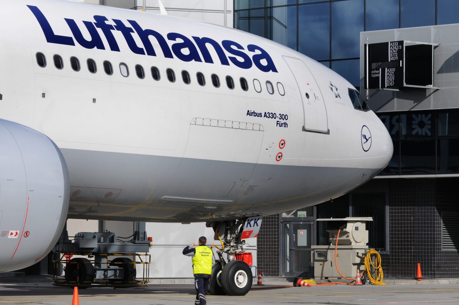 a man standing next to a large airplane