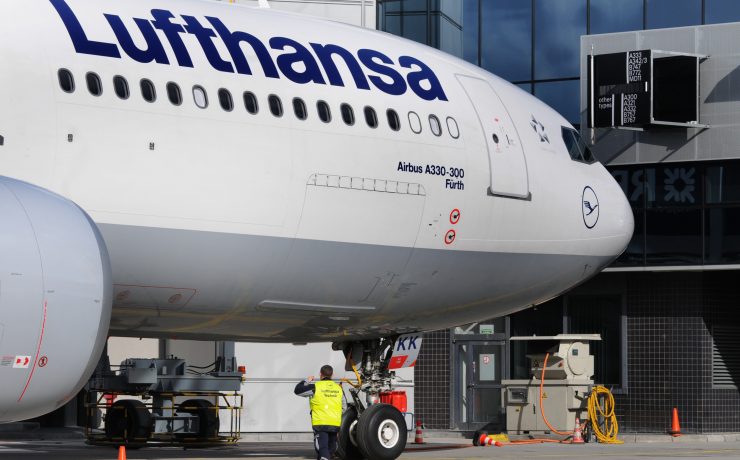 a man standing next to a large airplane