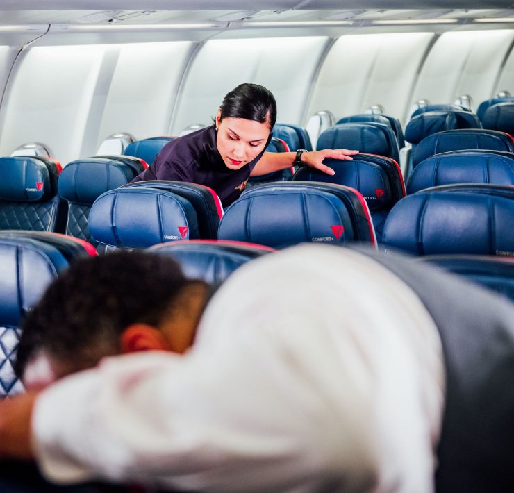 a woman sleeping on a plane