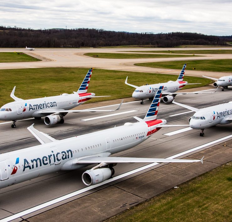 a group of airplanes on a runway