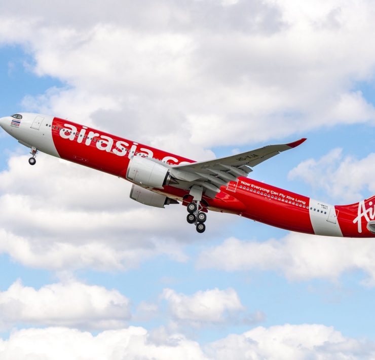 a red and white airplane flying in the sky