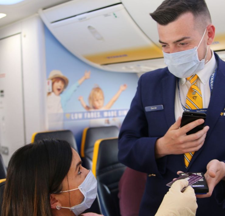 a man wearing a mask and holding a phone
