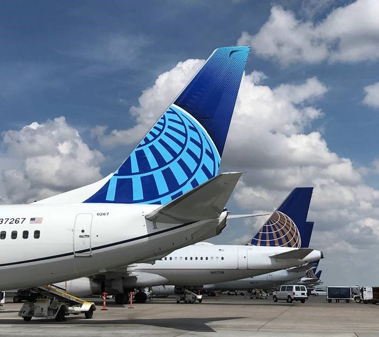 a group of airplanes parked on a runway
