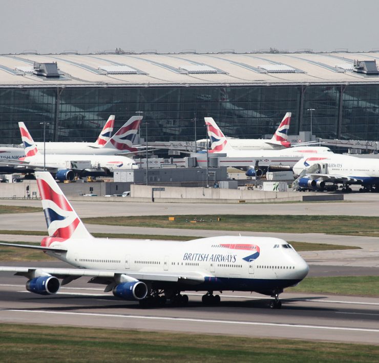 a group of airplanes on a runway