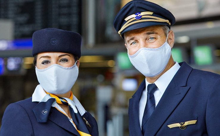a man and woman wearing masks