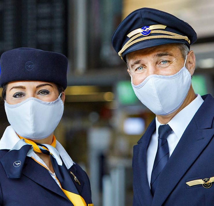 a man and woman wearing masks